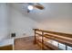 Loft space with hardwood flooring and a wooden railing overlooking lower level at 128 1St Street E. # 102, Tierra Verde, FL 33715