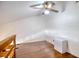 Loft area with hardwood floors, ceiling fan, and a view of the room below at 128 1St Street E. # 102, Tierra Verde, FL 33715
