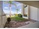 Cozy patio featuring a lush lawn, beautiful landscaping, and views of the nearby marina at 128 1St Street E. # 102, Tierra Verde, FL 33715