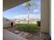 Patio view showcasing a garden with peagravel and pavers, leading to a stunning marina view at 128 1St Street E. # 102, Tierra Verde, FL 33715