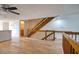 Hallway view leading to staircase with bathroom, kitchen, and living area access at 128 1St Street E. # 102, Tierra Verde, FL 33715