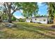 Large backyard with shade trees and a grass lawn at 1352 Parkwood St, Clearwater, FL 33755