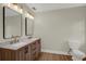 Bright bathroom with a double sink vanity, wood-look flooring, and modern fixtures at 1352 Parkwood St, Clearwater, FL 33755