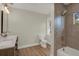 Well-lit bathroom featuring a double sink vanity, wood-look tile, and tiled walk-in shower at 1352 Parkwood St, Clearwater, FL 33755