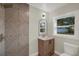 Updated bathroom with modern vanity, and tiled walk-in shower at 1352 Parkwood St, Clearwater, FL 33755
