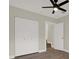 Bedroom featuring modern ceiling fan, closet and wood-look flooring at 1352 Parkwood St, Clearwater, FL 33755