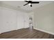 Bedroom featuring modern ceiling fan, closet and wood-look flooring at 1352 Parkwood St, Clearwater, FL 33755