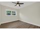 Well-lit bedroom with new windows and wood-look flooring at 1352 Parkwood St, Clearwater, FL 33755