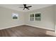 Sunlit bedroom featuring ceiling fan, neutral walls, and large windows at 1352 Parkwood St, Clearwater, FL 33755