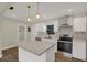 Bright kitchen with an island, stainless appliances, white cabinets, and subway tile backsplash at 1352 Parkwood St, Clearwater, FL 33755