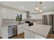 Modern kitchen with stainless steel appliances, white cabinets, island and stylish pendant lighting at 1352 Parkwood St, Clearwater, FL 33755