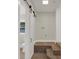 Laundry room with sliding barn door, natural lighting, and washer-dryer hookups at 1352 Parkwood St, Clearwater, FL 33755