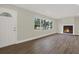 Bright living room with hardwood floors, a cozy fireplace, and large windows at 1352 Parkwood St, Clearwater, FL 33755