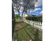 Fenced backyard with green grass and shrubbery surrounding the house at 13632 Deventer Ct., Hudson, FL 34667