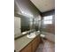 Bathroom featuring a single sink vanity and a glass-enclosed shower over tub at 13632 Deventer Ct., Hudson, FL 34667