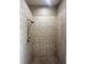 Bathroom with a shower stall featuring beige tile and a handheld shower head at 13632 Deventer Ct., Hudson, FL 34667