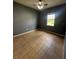 Bedroom with gray walls, tile flooring, ceiling fan and one window at 13632 Deventer Ct., Hudson, FL 34667