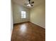 Well-lit bedroom with large window and tile flooring, complete with a ceiling fan at 13632 Deventer Ct., Hudson, FL 34667