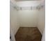 A standard walk-in closet includes carpet flooring and metal shelving for optimal storage and organization at 13632 Deventer Ct., Hudson, FL 34667