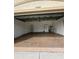 A two car garage with an included refrigerator, door, and some household items at 13632 Deventer Ct., Hudson, FL 34667