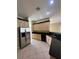 Kitchen with stainless steel refrigerator and sink with tile floor at 13632 Deventer Ct., Hudson, FL 34667