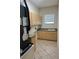 Functional laundry room with tile flooring, ample cabinet space, and a utility sink for added convenience at 13632 Deventer Ct., Hudson, FL 34667
