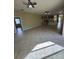 Spacious open-plan living room with tile flooring that flows into kitchen at 13632 Deventer Ct., Hudson, FL 34667