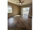 An airy living room is enhanced by tile floors, neutral colors, a ceiling fan, and natural light at 13632 Deventer Ct., Hudson, FL 34667