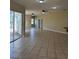 Open living room area with tile flooring and sliding glass doors to the outdoor space at 13632 Deventer Ct., Hudson, FL 34667