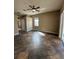 An airy living room is enhanced by tile floors, neutral colors, a ceiling fan, and natural light at 13632 Deventer Ct., Hudson, FL 34667