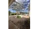Enclosed patio with covered pool and view of white picket fence and nearby home at 13632 Deventer Ct., Hudson, FL 34667