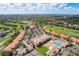 Community aerial view showcases the pool, clubhouse, golf course, and lush green surroundings at 13941 Clubhouse Dr # 308, Tampa, FL 33618