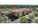 Aerial view featuring condo building, private balconies, and pool, surrounded by lush landscaping at 13941 Clubhouse Dr # 308, Tampa, FL 33618