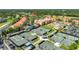 Beautiful aerial showcasing the tennis courts, pool, and the condo buildings against a backdrop of greenery at 13941 Clubhouse Dr # 308, Tampa, FL 33618