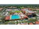 Aerial view showcasing community pool, tennis courts, playground, and surrounding lush landscaping at 13941 Clubhouse Dr # 308, Tampa, FL 33618