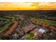 Golden hour aerial view of the expansive community featuring golf course, pool, and lush surroundings at 13941 Clubhouse Dr # 308, Tampa, FL 33618