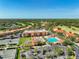 Stunning aerial of the community showcasing pool, tennis courts, golf course, and lush surrounding landscape at 13941 Clubhouse Dr # 308, Tampa, FL 33618