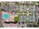 Aerial shot showcasing eight tennis courts, and a pool with lounge chairs at the community recreational facility at 13941 Clubhouse Dr # 308, Tampa, FL 33618