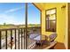 Private balcony with seating, overlooking lush greenery and serene surroundings at 13941 Clubhouse Dr # 308, Tampa, FL 33618