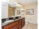 Bathroom featuring double sinks, granite countertops, and a tiled shower for a luxurious experience at 13941 Clubhouse Dr # 308, Tampa, FL 33618
