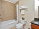 Bathroom featuring bathtub with shower and granite sink at 13941 Clubhouse Dr # 308, Tampa, FL 33618