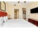 Bedroom with a king bed, dresser, and views into the hallway and bathroom for easy access at 13941 Clubhouse Dr # 308, Tampa, FL 33618