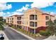 Exterior view of a multi-story condominium building boasting private balconies and colorful facade at 13941 Clubhouse Dr # 308, Tampa, FL 33618