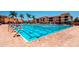 Expansive community pool with numerous lap lanes, seating and colorful building exterior at 13941 Clubhouse Dr # 308, Tampa, FL 33618
