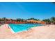 Large community pool with lap lanes surrounded by seating and lush tropical landscaping at 13941 Clubhouse Dr # 308, Tampa, FL 33618