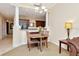 Comfortable dining area with seating for four, open to the kitchen, featuring a modern chandelier at 13941 Clubhouse Dr # 308, Tampa, FL 33618