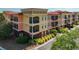 Bright, multi-story condo building featuring private balconies and well-maintained landscaping at 13941 Clubhouse Dr # 308, Tampa, FL 33618