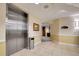 Hallway with elevator access, neutral walls and tile flooring, and unit signage at 13941 Clubhouse Dr # 308, Tampa, FL 33618