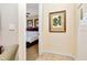 Hallway leading into bedroom featuring white walls, decorative painting and an electrical outlet at 13941 Clubhouse Dr # 308, Tampa, FL 33618