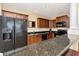 Kitchen with black appliances and dark granite countertop breakfast bar at 13941 Clubhouse Dr # 308, Tampa, FL 33618